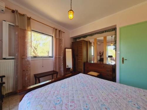 a bedroom with a bed and a dresser and a mirror at LECÉLESTE in Lithakia