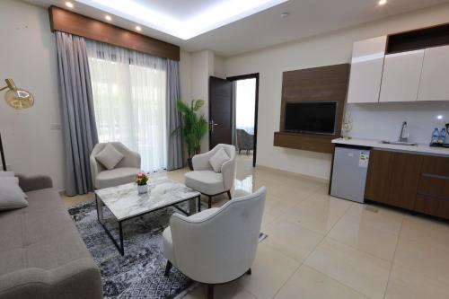 a living room with a couch and a table at Palm Boutique Suites Hotel in Beirut