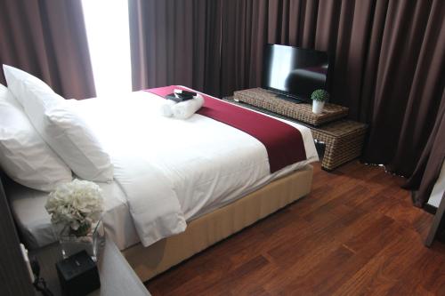 Ένα ή περισσότερα κρεβάτια σε δωμάτιο στο Nexus Business Suite Hotel