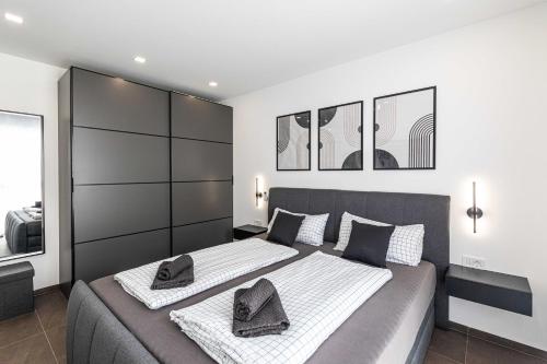 a bedroom with two beds with white and black at Villa Pavlina in Kaštela