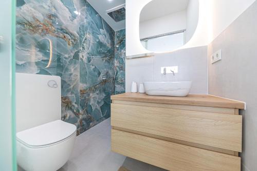 a bathroom with a toilet and a sink at Villa Pavlina in Kaštela