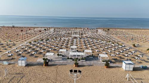 a large group of umbrellas on a sandy beach at Savoy Beach Hotel & Thermal Spa in Bibione