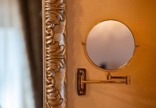 a mirror attached to a wall with a handle at Torciano Hotel Wine & Winery, Tuscany in San Gimignano