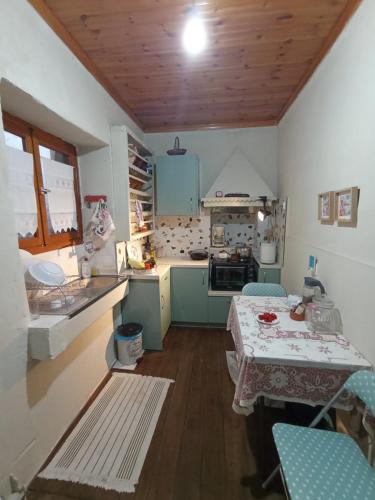 a small kitchen with a table and chairs in it at Beautiful Pelion Guesthouse with Spectacular Views in Anilio Pelion