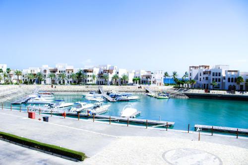 a view of a marina with boats in the water at Wateera Jebel Sifah in As Sīfah