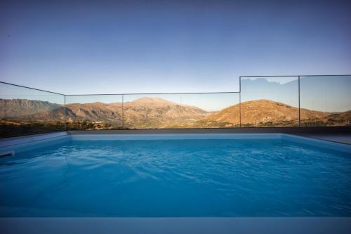 a swimming pool with a view of mountains at Luxury apartment with rooftop pool in Meronas in Méronas