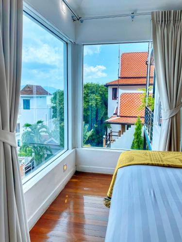 a bedroom with a large window and a bed at Celebrity Ocean View Villa Samui in Bang Rak Beach