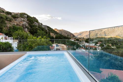 a swimming pool with a view of a mountain at Luxury apartment with rooftop pool in Meronas in Méronas