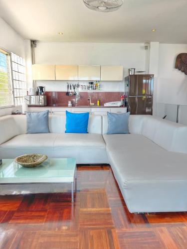 a living room with a white couch and a table at Celebrity Ocean View Villa Samui in Bang Rak Beach
