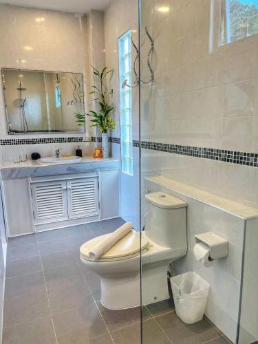 a bathroom with a toilet and a sink and a mirror at Celebrity Ocean View Villa Samui in Bang Rak Beach
