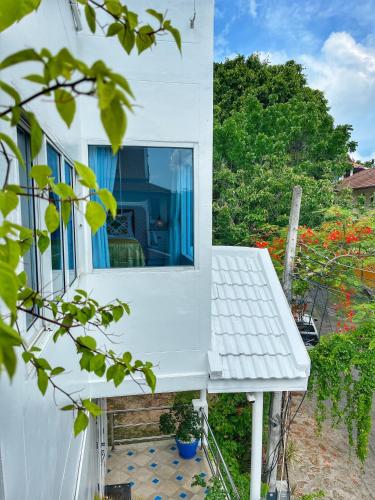 a white house with a window and a bench at Celebrity Ocean View Villa Samui in Bang Rak Beach