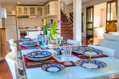 a table with blue and white plates on it at Celebrity Ocean View Villa Samui in Bang Rak Beach