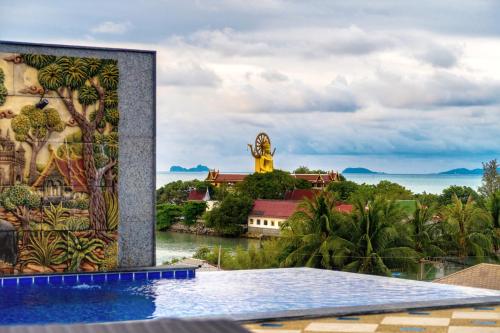a pool at the resort with a view of the ocean at Celebrity Ocean View Villa Samui in Bang Rak Beach