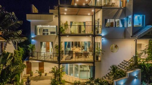 an apartment building with a balcony with a table at Celebrity Ocean View Villa Samui in Bang Rak Beach
