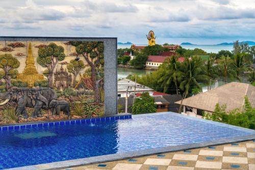 a mural on the side of a building with a swimming pool at Celebrity Ocean View Villa Samui in Bang Rak Beach