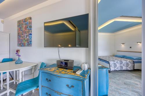 a room with a blue cabinet and a bed at Debeli Rtič Apartments in Ankaran