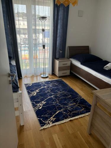 a bedroom with a bed and a blue rug at Large apartment in Ulm