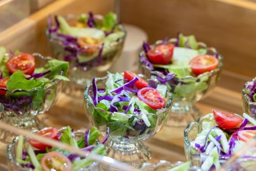 a group of small glass vases filled with salads at Atour Hotel Qidong Wenfeng World People's West Road in Qidong