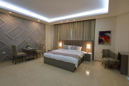 a hotel room with a bed and a table and chairs at Palm Boutique Suites Hotel in Beirut