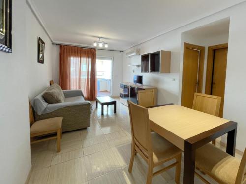 a living room with a table and a dining room at Apartamentos 3000 Marina D'Or in Oropesa del Mar