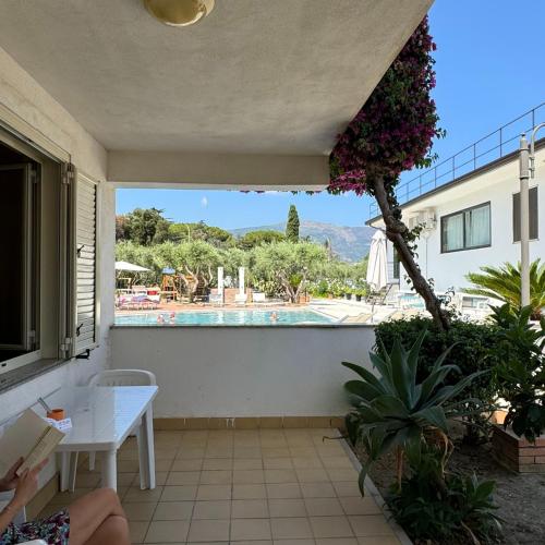 a patio with a table and a swimming pool at Medimare Residence Club in Patti