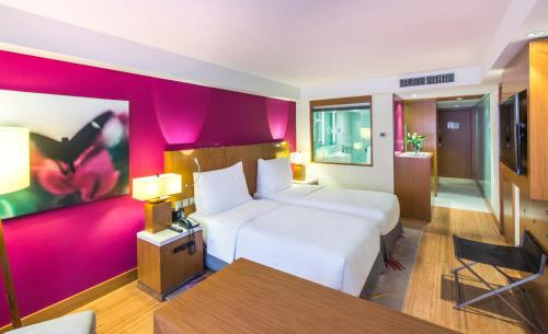 a bedroom with a large white bed and a table at Radisson Blu Hotel, Kuwait in Kuwait