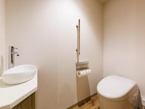 a bathroom with a toilet and a sink at JR East Hotel Mets Premier Makuhari Toyosuna in Chiba