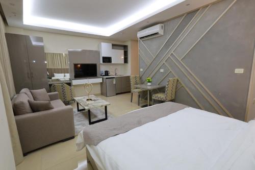 a hotel room with a bed and a living room at Palm Boutique Suites Hotel in Beirut