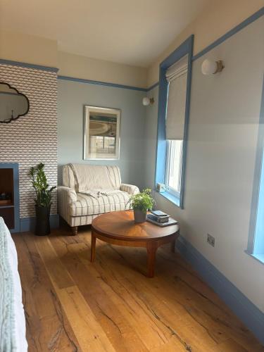 a living room with a couch and a coffee table at The London & Paris Hotel in Folkestone