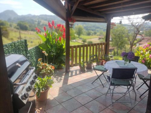 a patio with a table and chairs and a grill at Casa Malba in Sevares