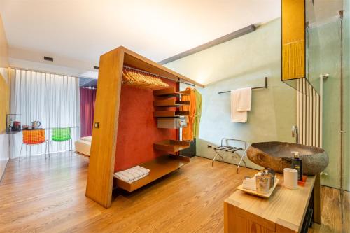 a bathroom with a sink and a wooden table at Ambienthotel PrimaLuna 3S in Malcesine
