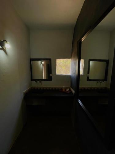 a dark room with two mirrors on the wall at Riad Sahara Sunset Beach Douira in Agadir