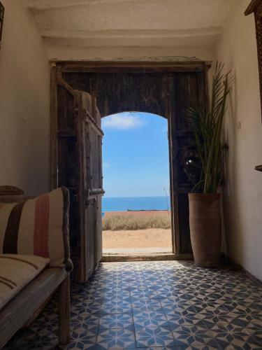 an open door with a view of the beach at Riad Sahara Sunset Beach Douira in Agadir