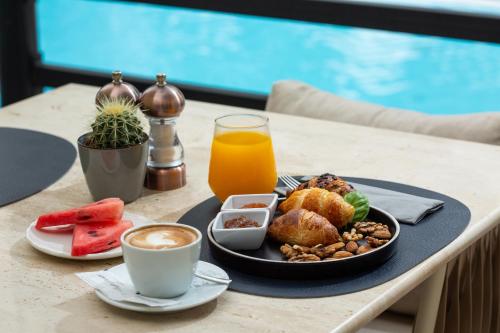 a table with a plate of food and a cup of coffee at SeeSea Hotel in Vodice