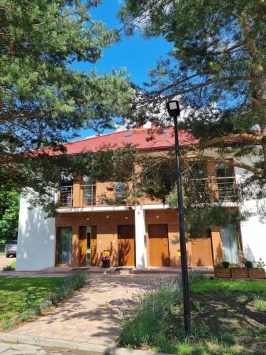 a house with a street light in front of it at LAGUNA Loftowy na Wzgórzu in Polanica-Zdrój