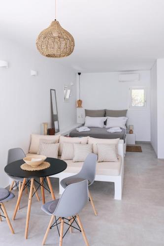 a living room with a couch and a table and chairs at Anastasia Kimolos in Kimolos
