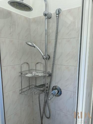 a shower with a shower head in a bathroom at Casa del Pescatore RDA LUXURY APARTMENTS in Bordighera