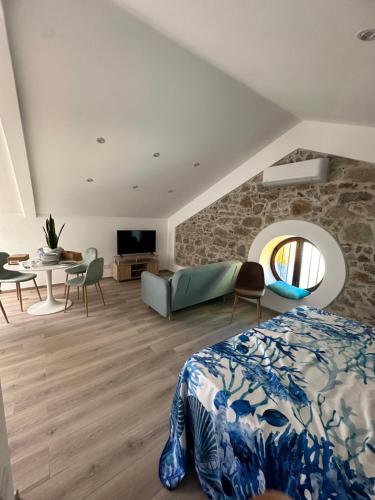 a bedroom with a bed and a stone wall at Hotel Marinella in Sanremo
