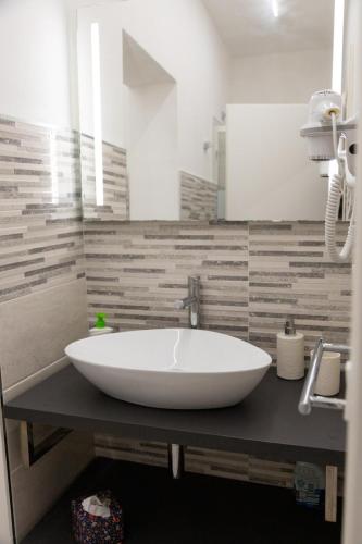 a bathroom with a large white sink on a counter at Pietre Azzurre Rooms in Pachino