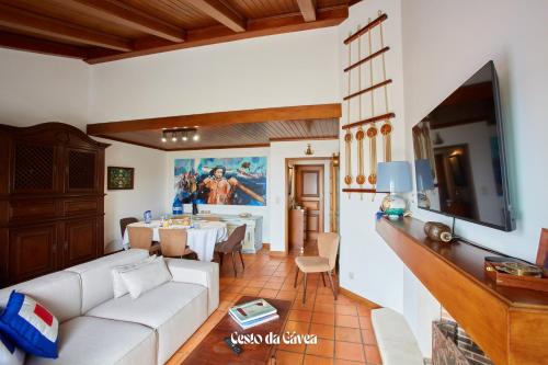 a living room with a white couch and a table at Cesto da Gávea in Praia da Barra