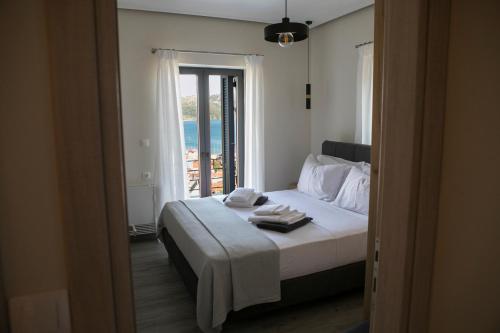 a bedroom with a bed with towels on it at Villa Panorama in Astakós