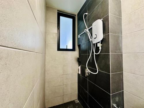 a shower in a bathroom with a window at World Class Apartment In Georgetown 3BR in Jelutong