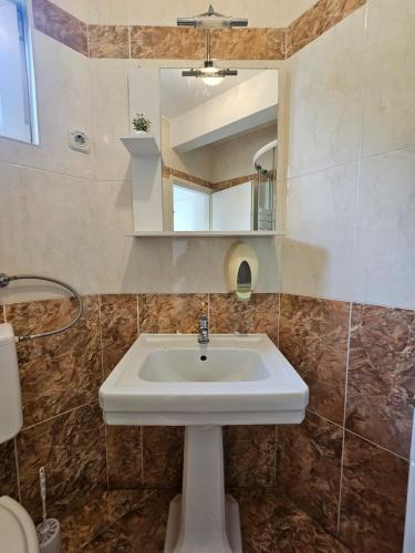 a bathroom with a sink and a mirror at Guest house Silvija - sea view in Primošten