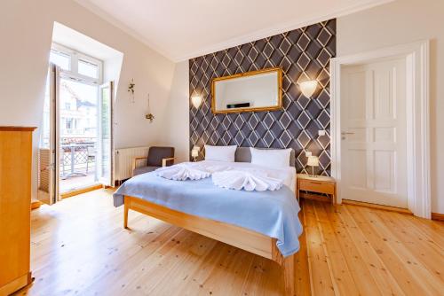 a bedroom with a large bed with a wall at Villa Glaeser in Bansin