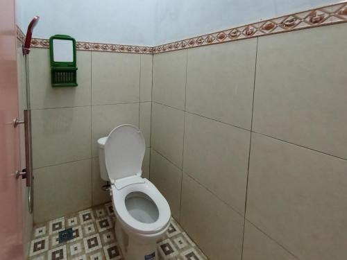 a small bathroom with a toilet in a stall at Surya Abadi Homestay Syariah RedPartner in Kebumen