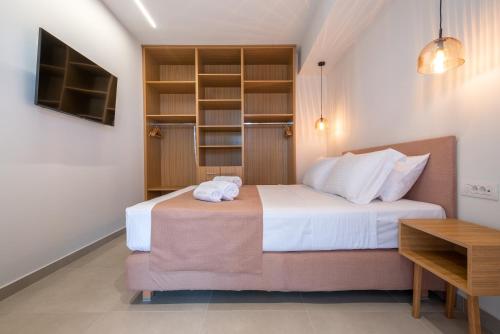 a bedroom with a bed and a book shelf at Anni Seafront Studios in Plati