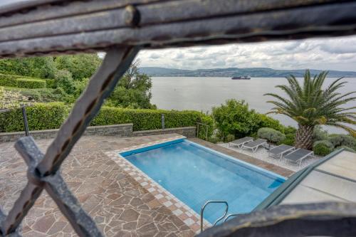 a swimming pool with a view of the water at Debeli Rtič Apartments in Ankaran