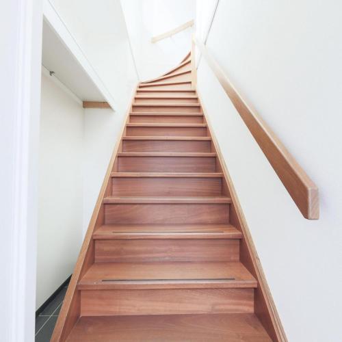 a staircase in a house with wooden floors at Weststraat 22 - Ouddorp - Appartement Oost 3P in Ouddorp