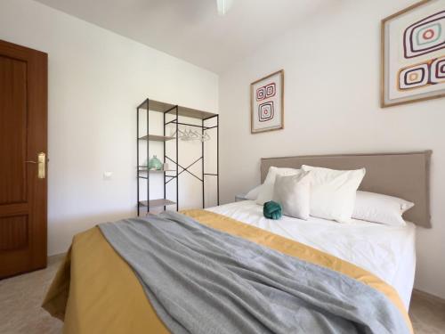 a bedroom with a large bed with white pillows at RosaritoHomes in Madrigal de la Vera