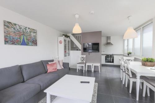 a living room with a couch and a table at Weststraat 22 - Ouddorp - Appartement Oost 3P in Ouddorp